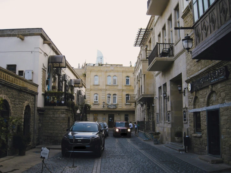 two cars parked on a narrow city street