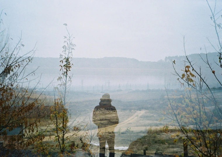 a person standing on top of a lush green hillside