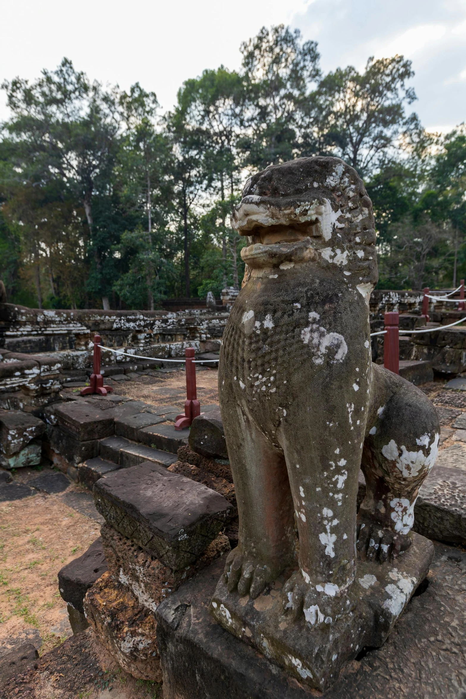 an elephant sitting in the middle of some stones