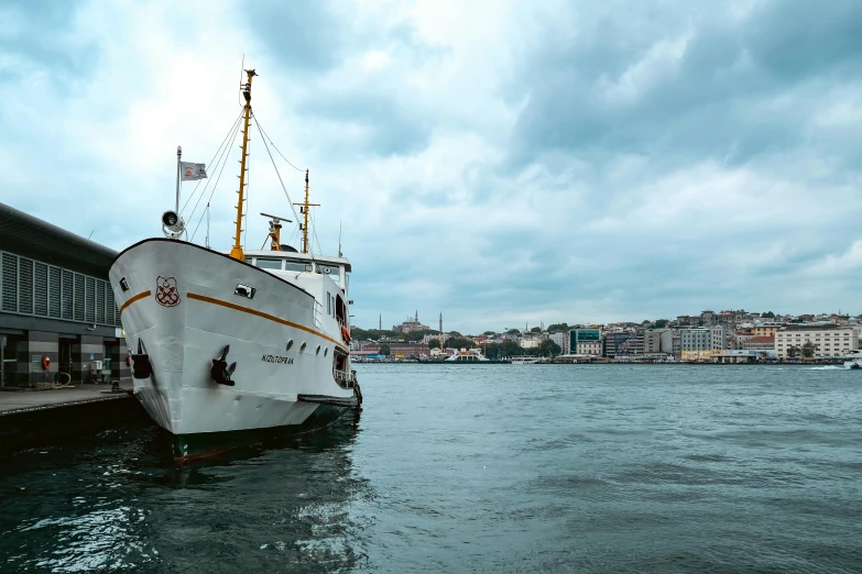 a large white boat sitting in the water by the pier