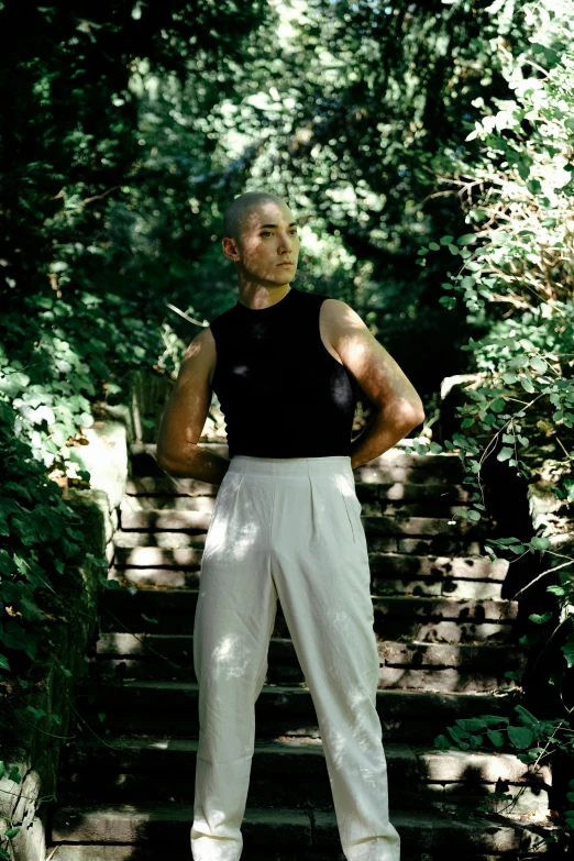 a person wearing all black standing on some steps