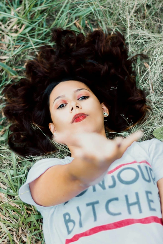 an image of a beautiful girl laying in grass