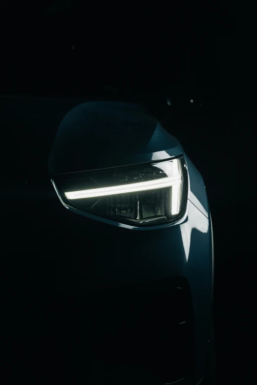 the rear light of a modern car illuminated at night