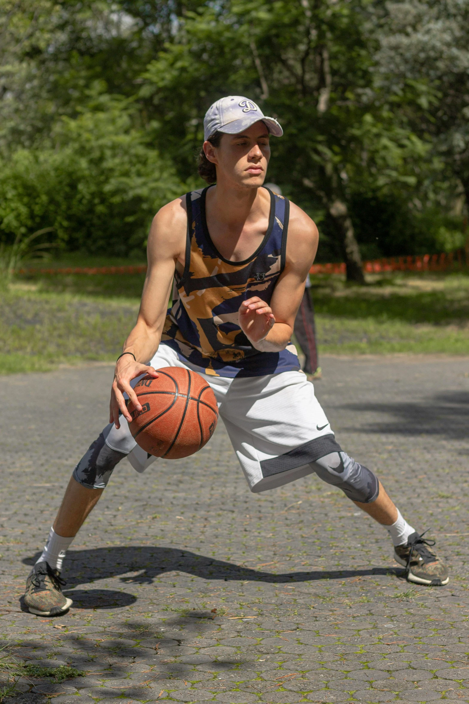 young man in patterned shirt holding a basketball
