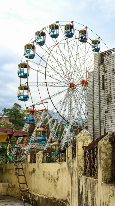 an old abandoned area with a carnival attraction in the distance