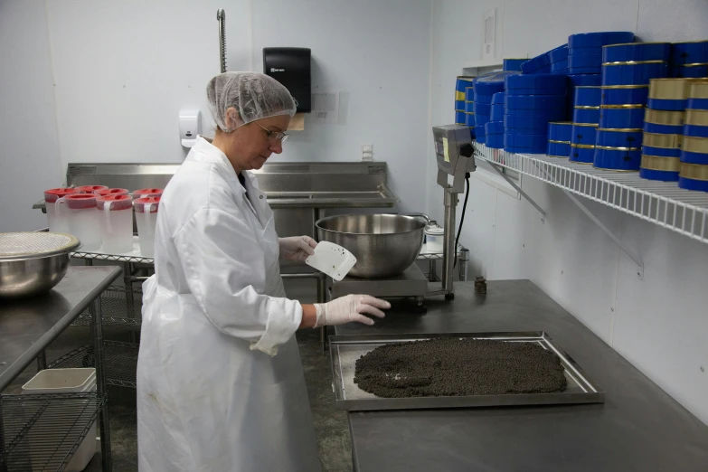 a woman in a kitchen with lots of shelves