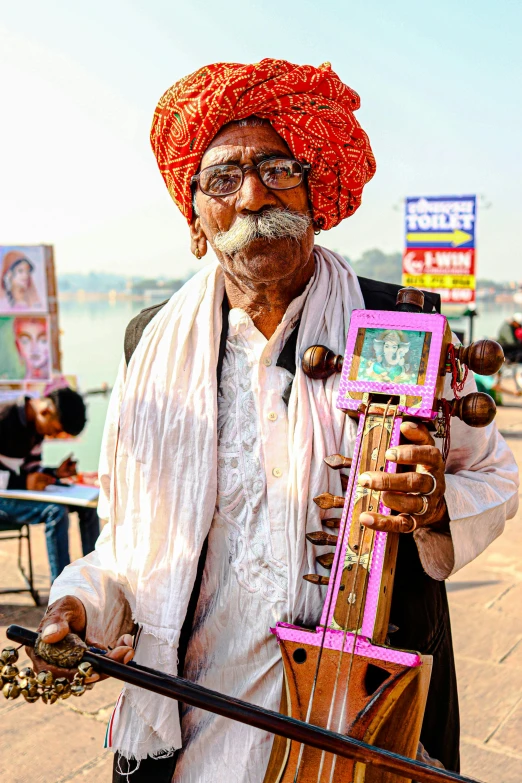 a man holding a pink and black musical instrument