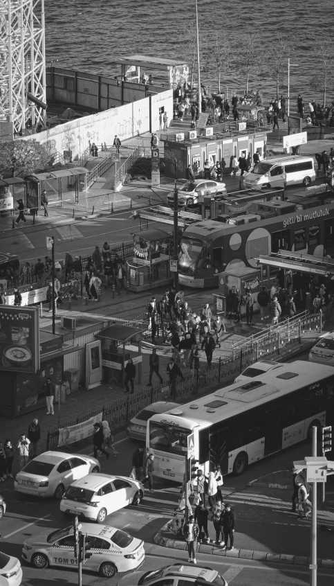 a busy city street with buses, cars, and pedestrians