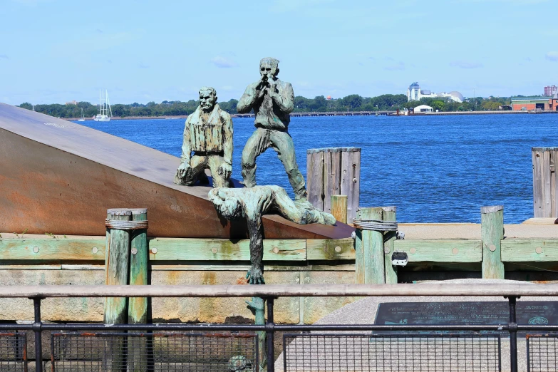 a statue is in front of a body of water