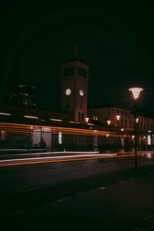 long exposure s of a clock tower with lights and motion blurs around it