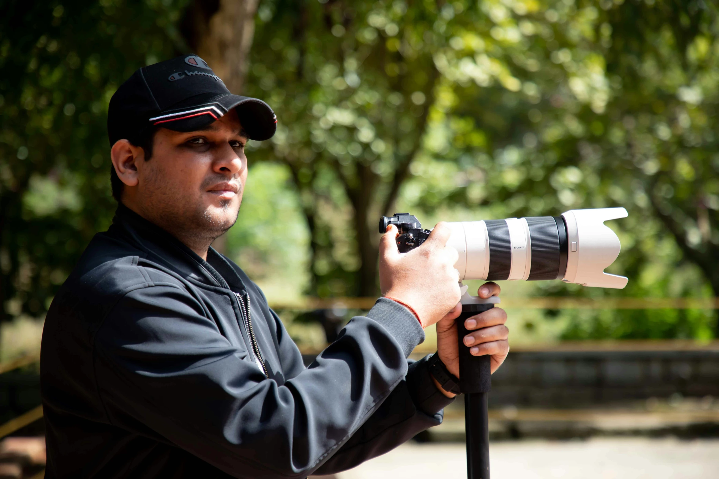 a man with a hat on holding a camera