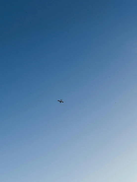 an airplane is flying in the clear blue sky