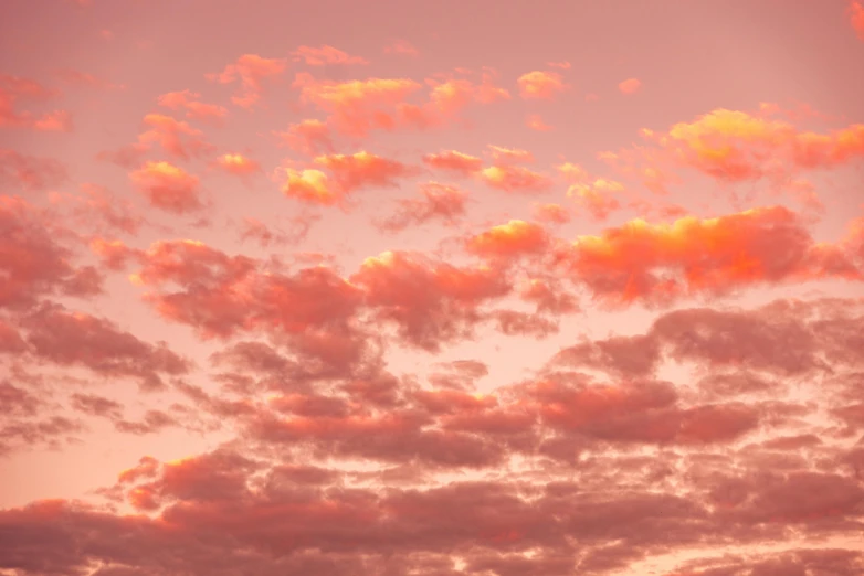 a sunset with bright pink clouds and no one