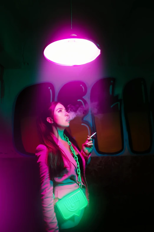 a young lady is posing in a neon room while smoking a cigarette