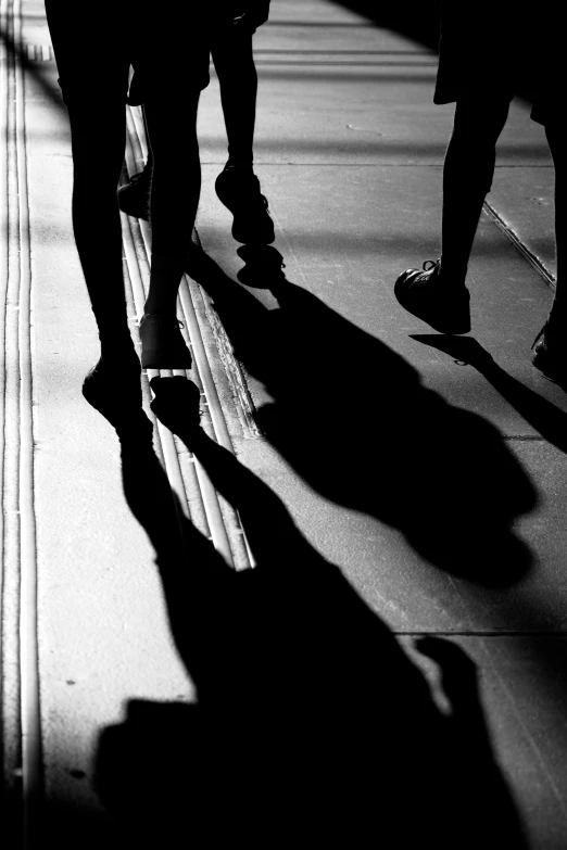 a person in silhouette walks on a city street