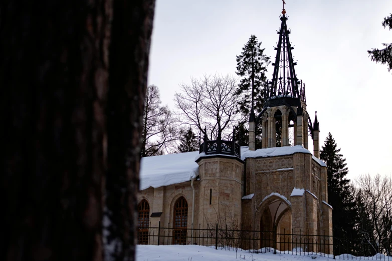 a snow covered church sits on the side of a hill
