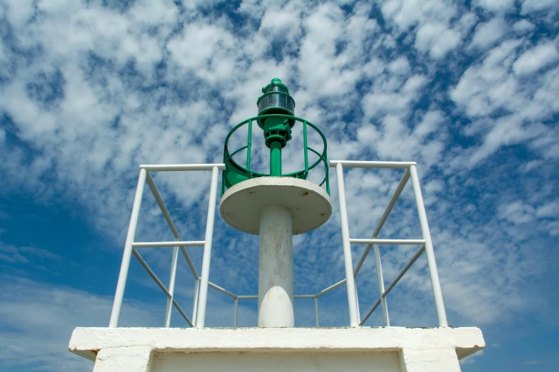 a lighthouse has a green light on it