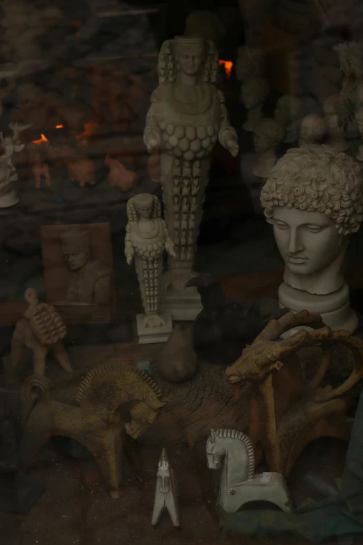 assorted statues and a lion inside a glass display case