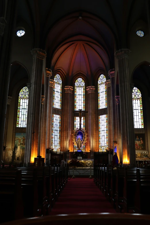 the inside of a church with several stained glass windows