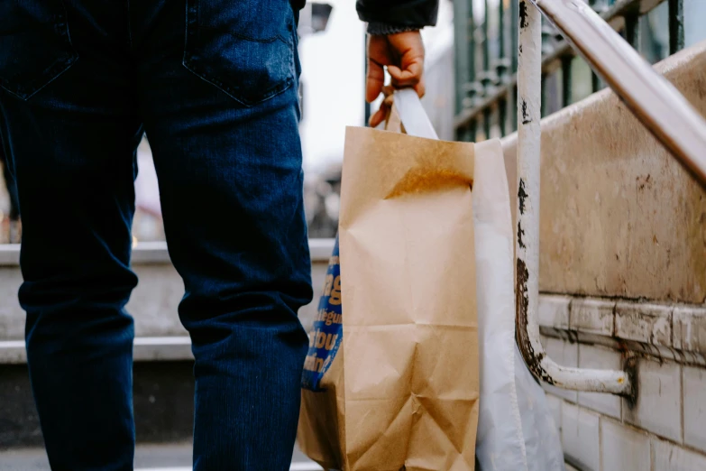 a person walking down some steps carrying bags