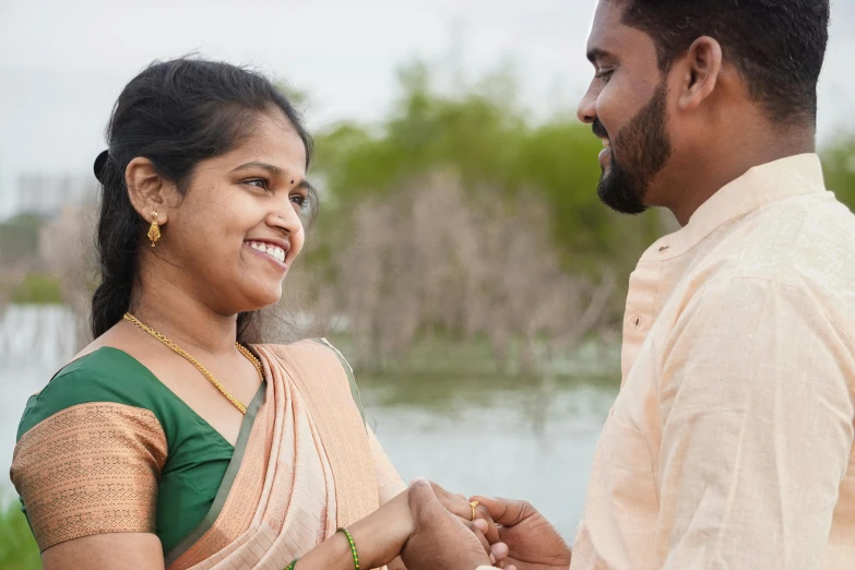 couple looking at each other near water during their outdoor wedding ceremony