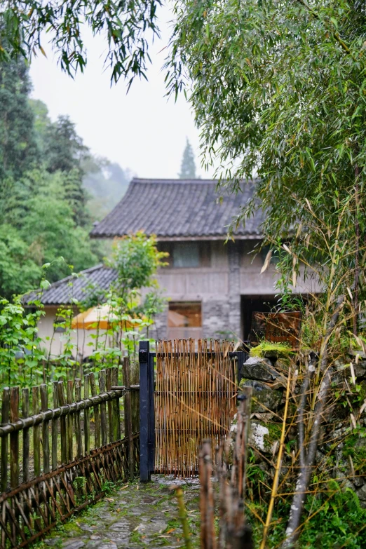 an open gate leading to an old stone building