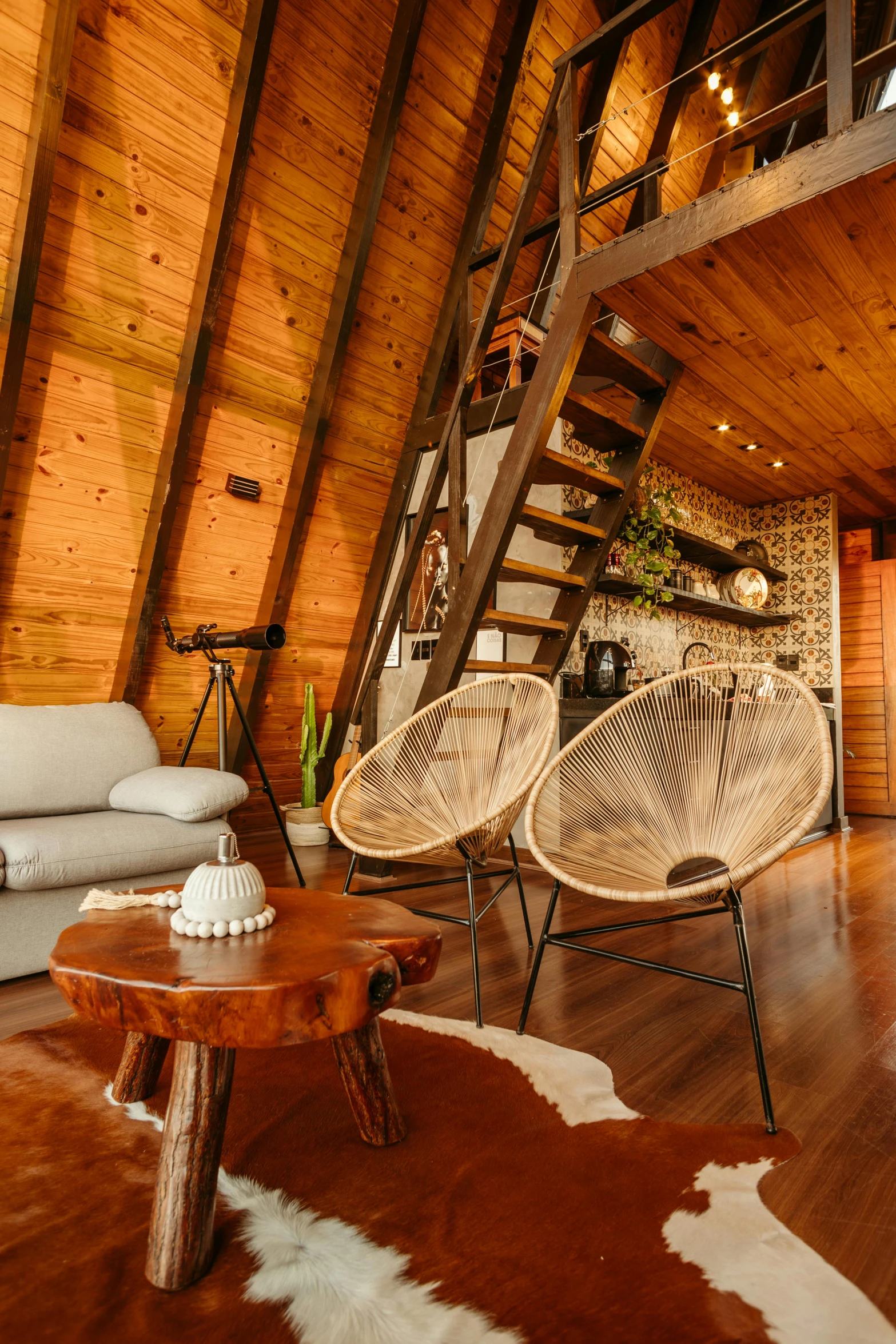 a chair, a table, and a stool in an open room