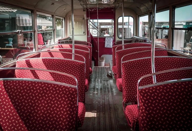 red and white buses inside a bus with lots of seats