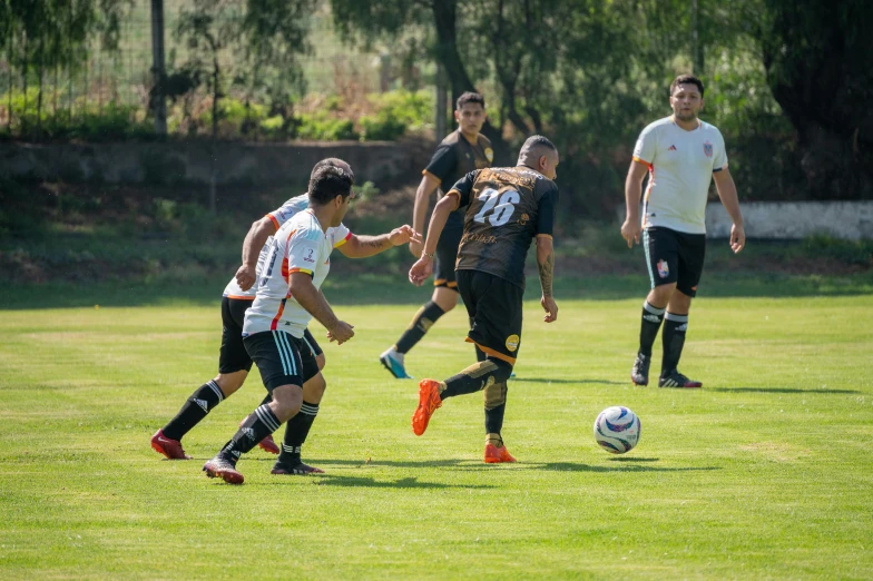 a group of young men kicking around a soccer ball