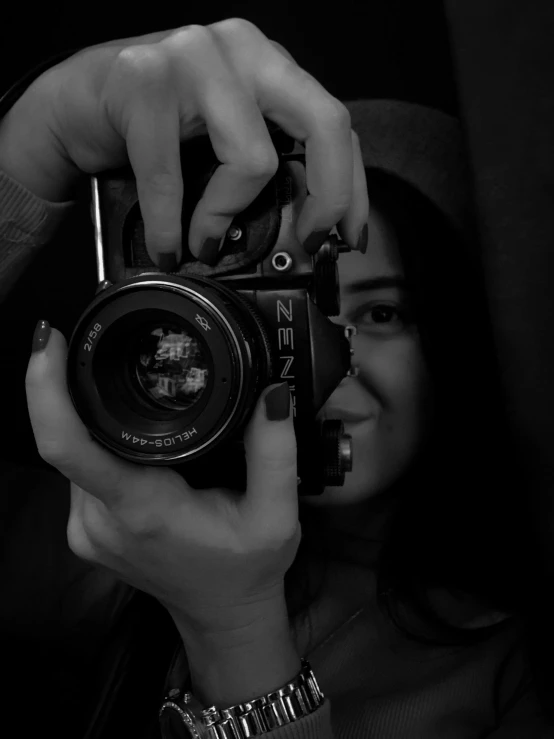 a black and white po of two people holding a camera