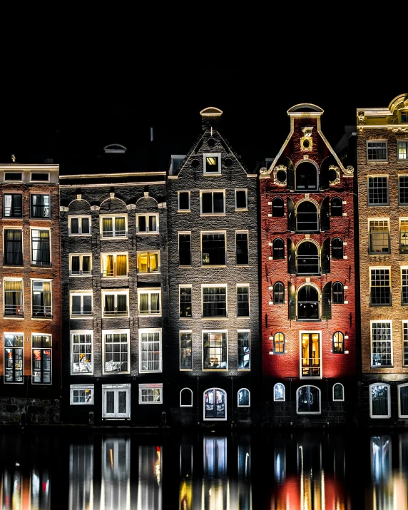 a large group of houses with lights over them