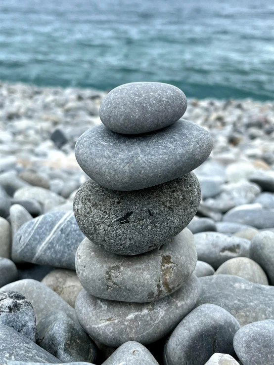 rocks stacked in the shape of letters sitting on a beach