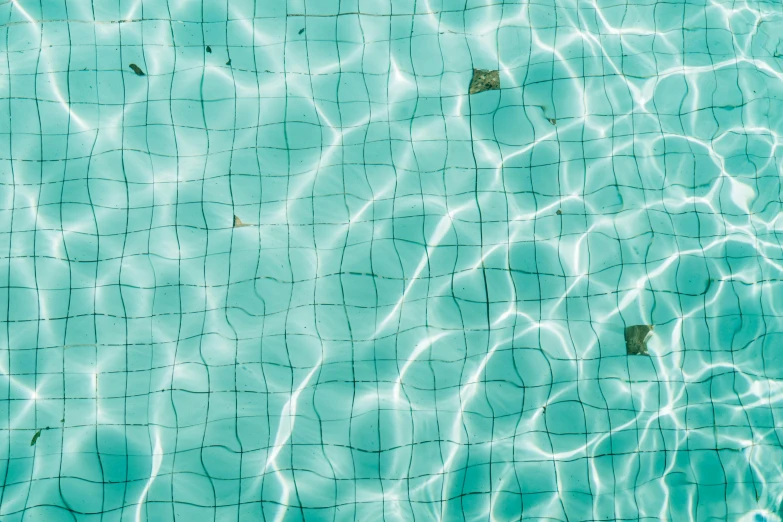water with no ripples is shown from the top of a swimming pool
