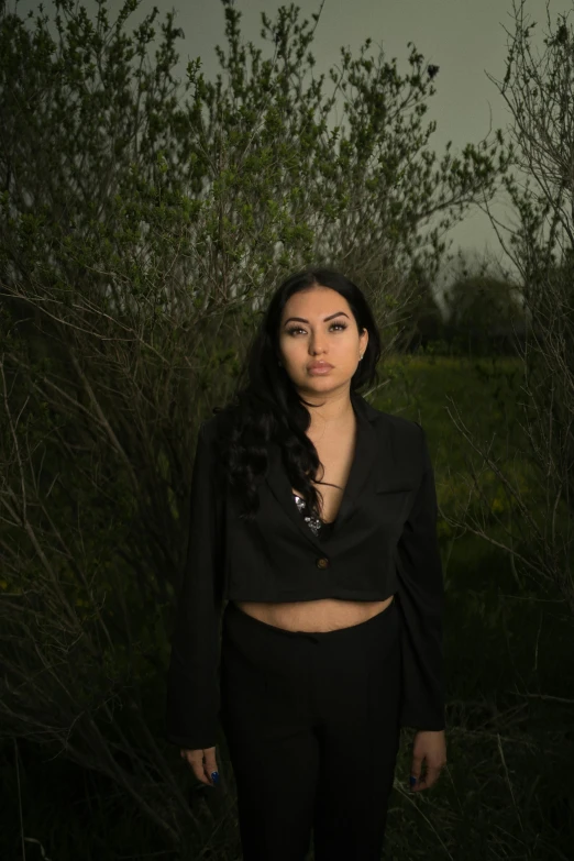 a woman is standing with long black hair