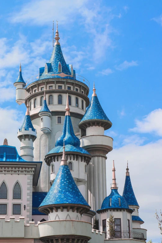 the top of a castle under a blue cloudy sky