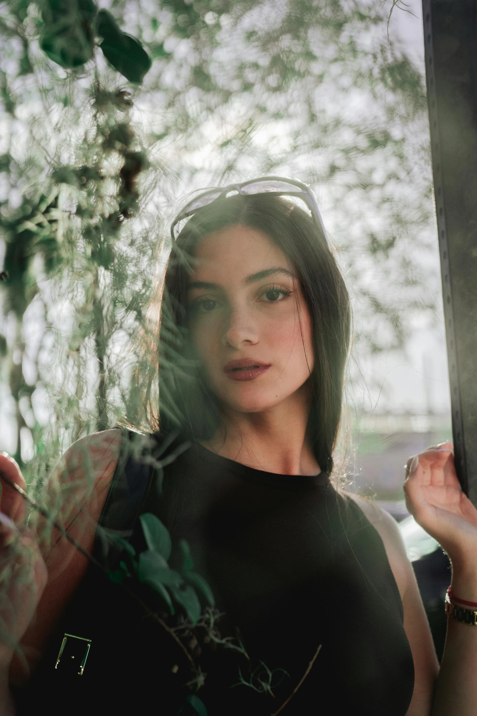 woman in black shirt holding out a window sill