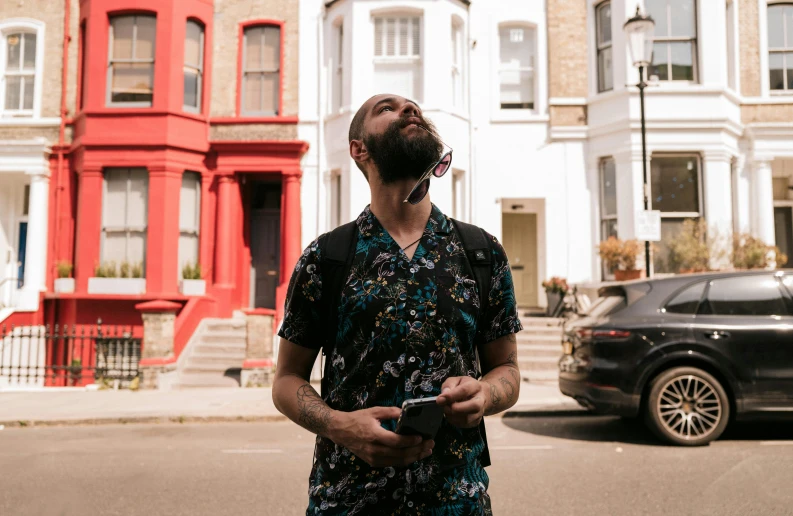 a man standing in front of some row houses