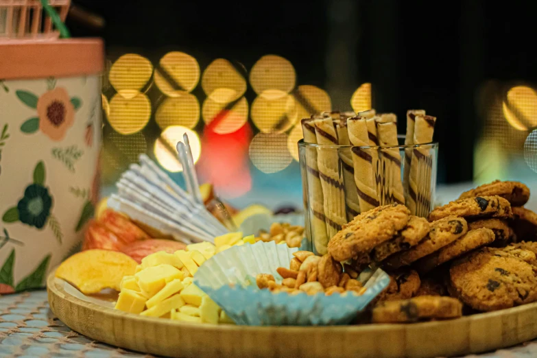 assorted snacks are on display with decorative tins