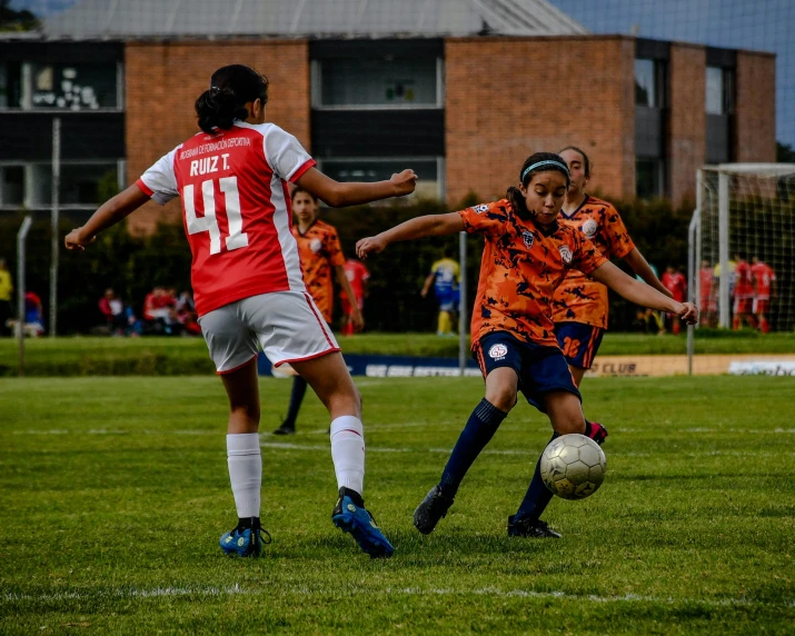 a group of young people playing a game of soccer