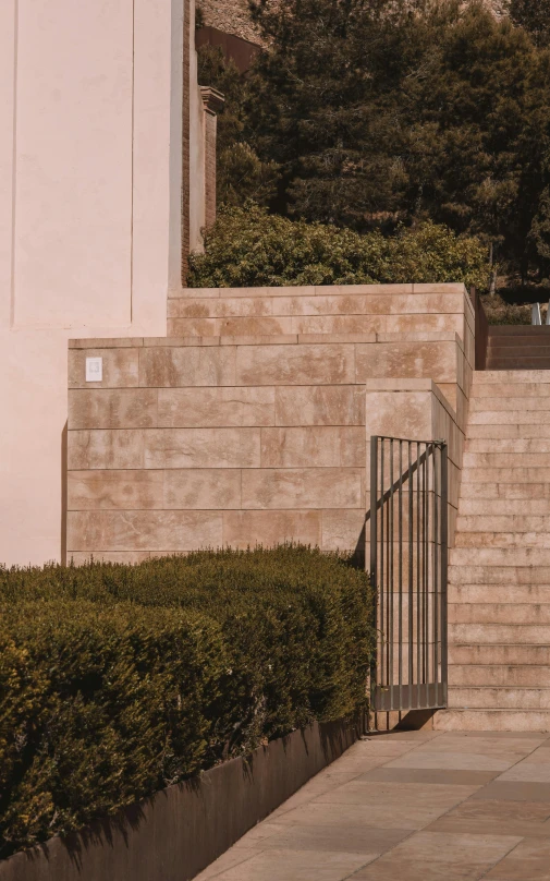 a man walking past stairs, holding his umbrella