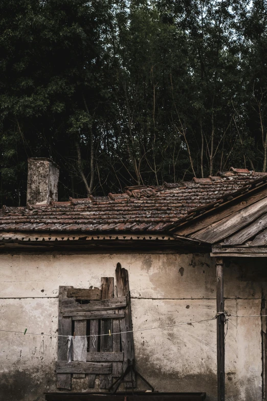 a rundown house with a broken down window