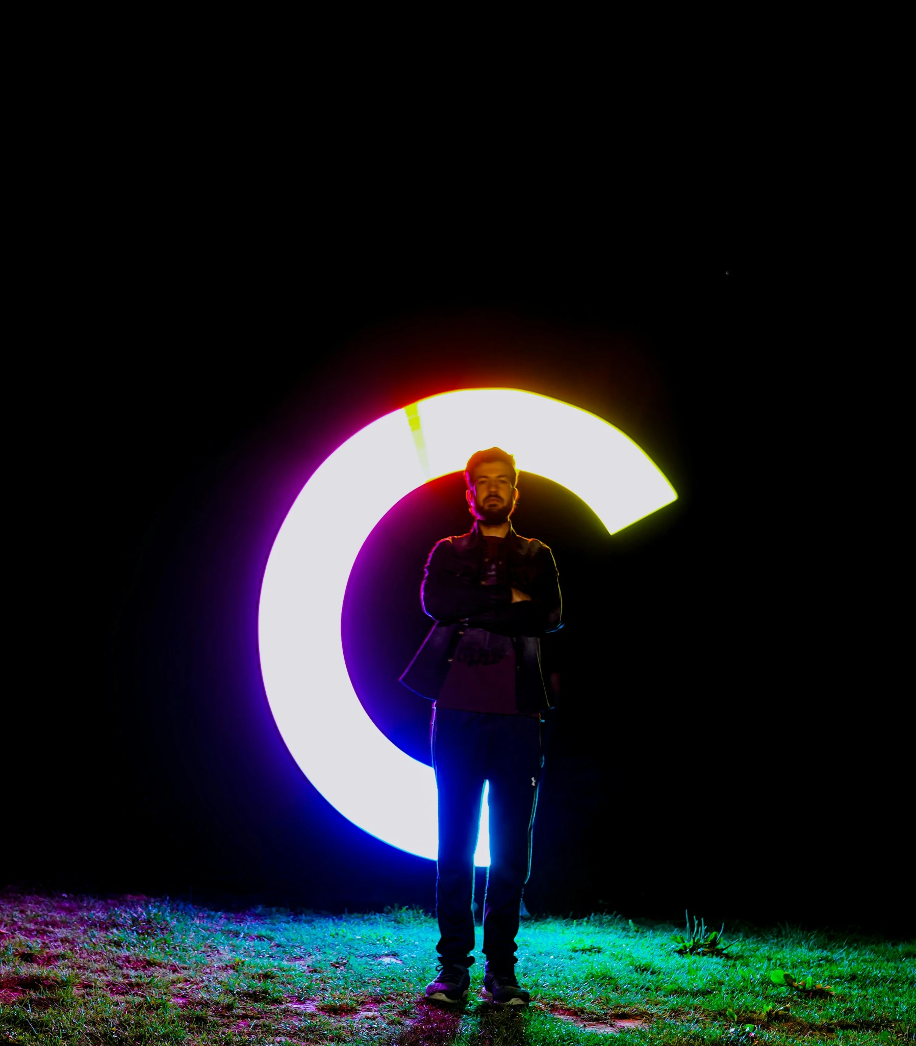 man standing in front of bright and circular object