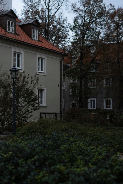 a tall building sitting next to a lush green forest