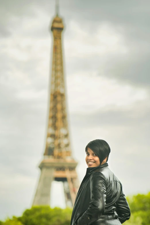 a woman in front of the eiffel tower