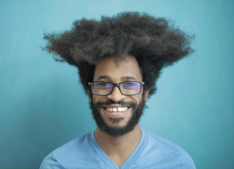 an african man with a beard and eyeglasses with afro