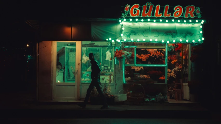 a man walks down a street in front of a business