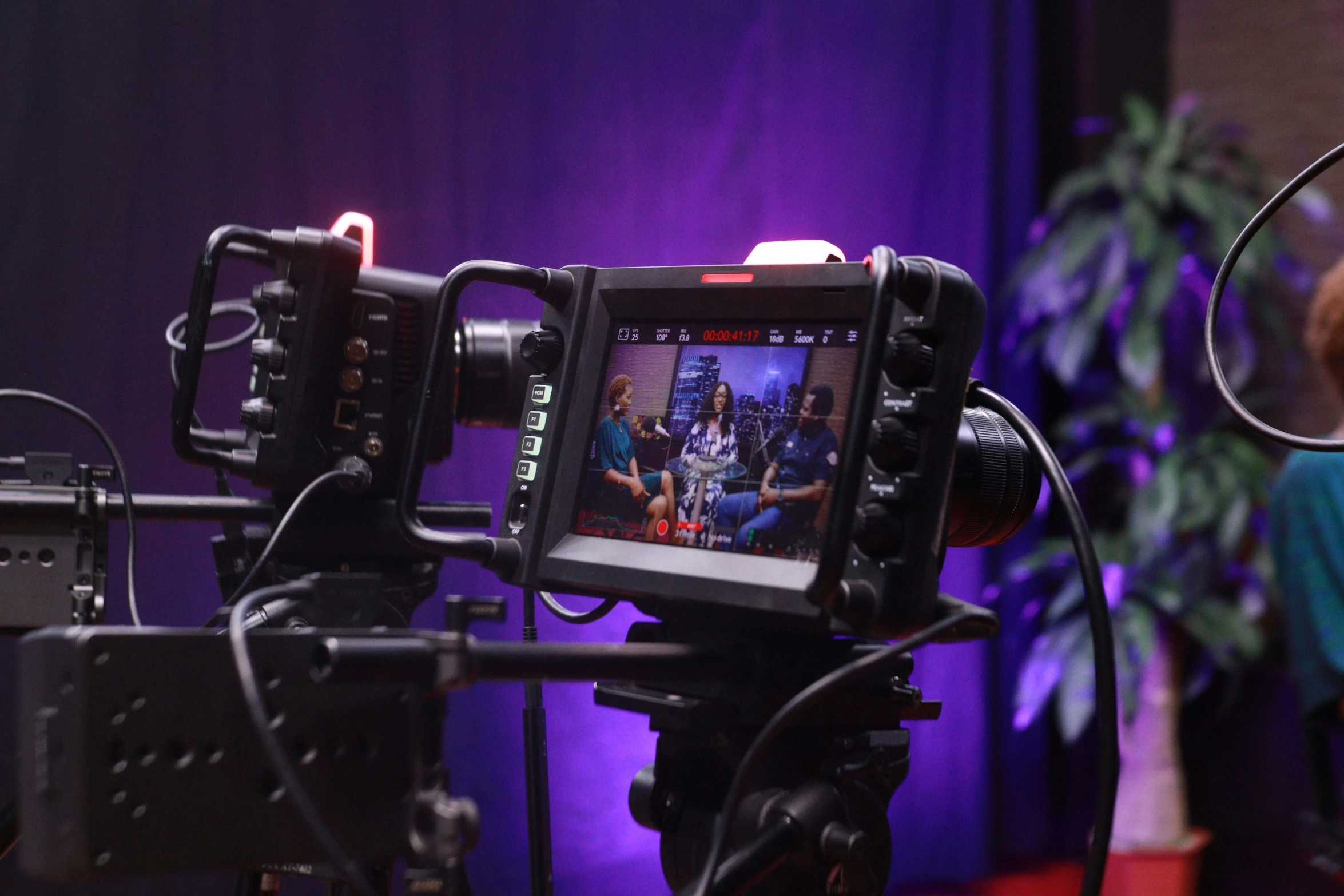 a video camera being recorded as a woman and man stare on