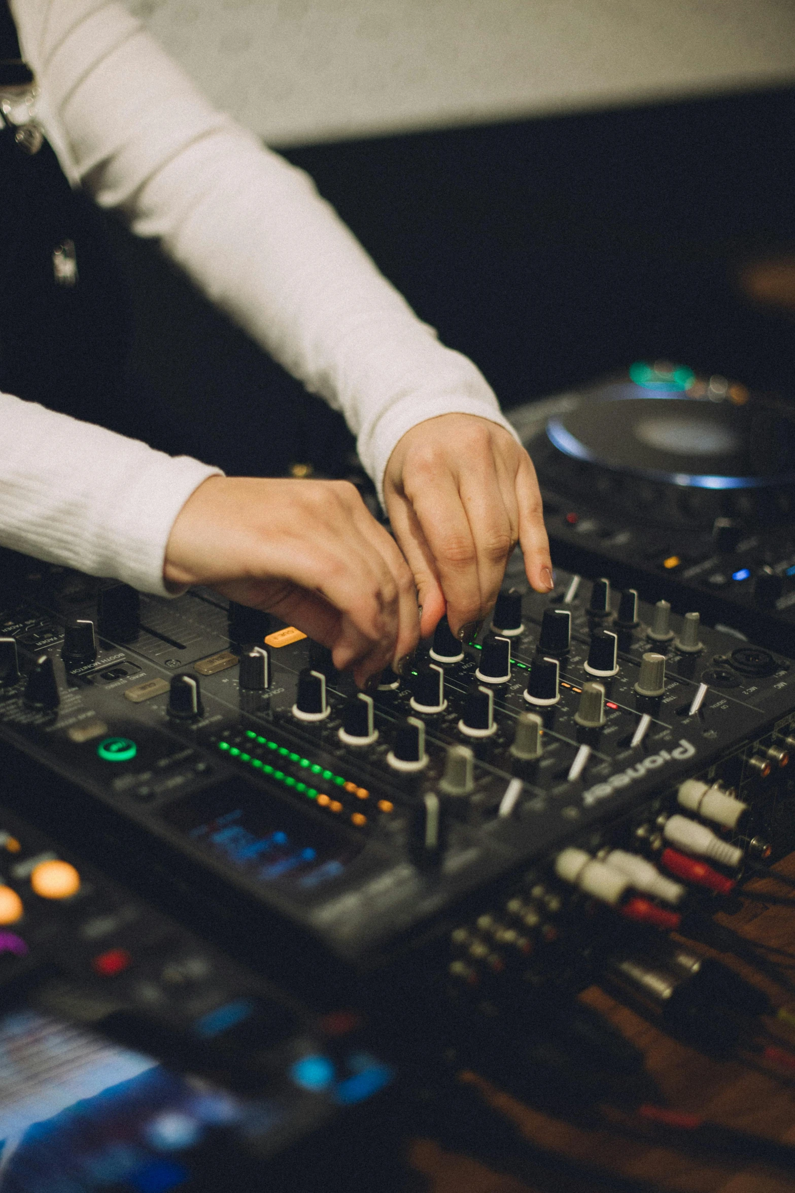 hands on the controller of a large mixing table