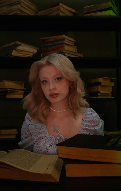 the blonde haired girl is studying a book