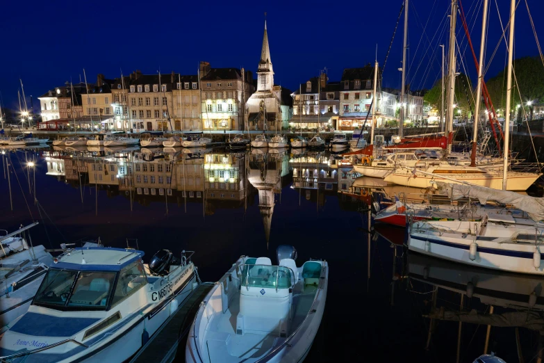 the boats are docked in the harbor next to the building